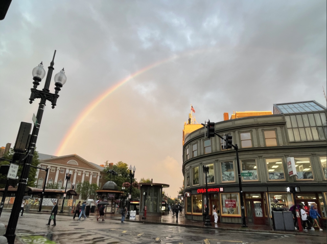 Rainbow at dusk over the Harvard MBTA subway station right after a rainstorm.