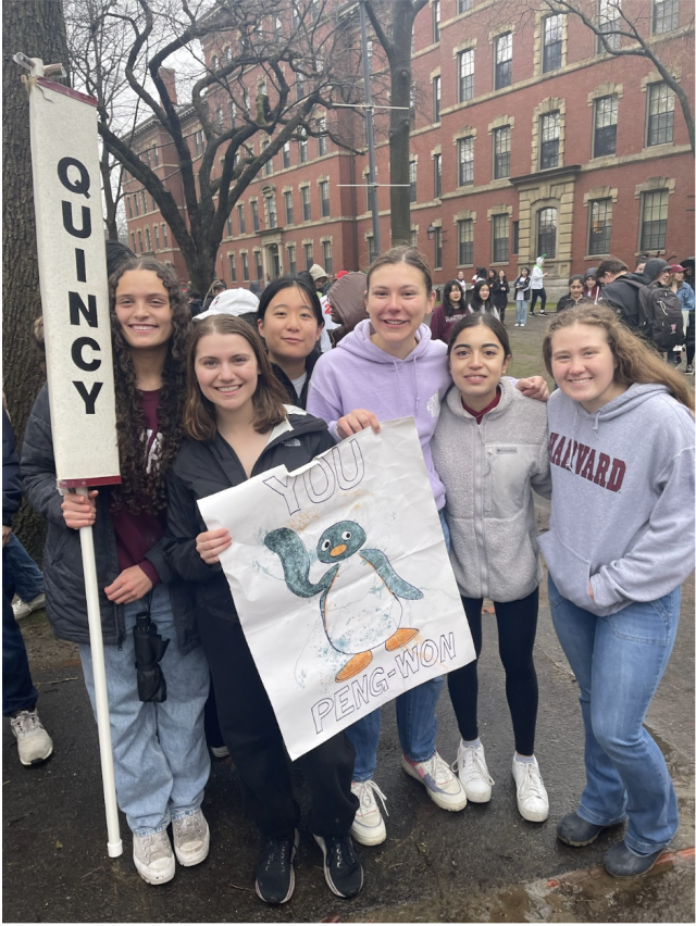 Blocking group posed with Quincy signs 