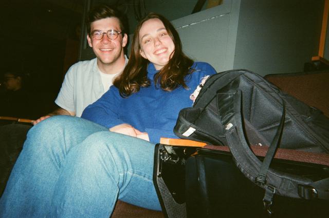 Photo of two people sitting in an auditorium