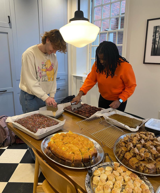 My coworker and I cutting treats to be served at Lowell Tea.