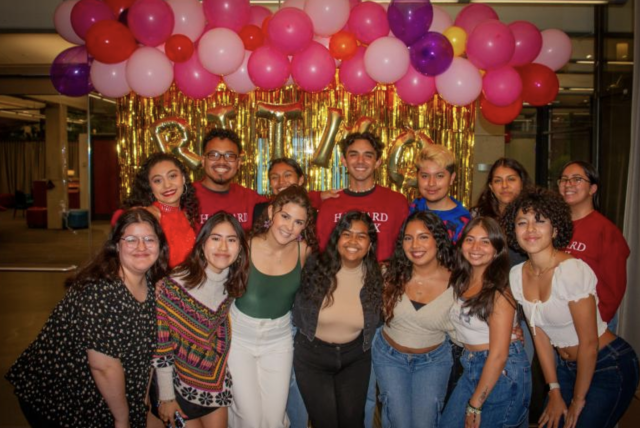 Fuerza Latina Board Posing In Front of a Ritmo Latino Sign