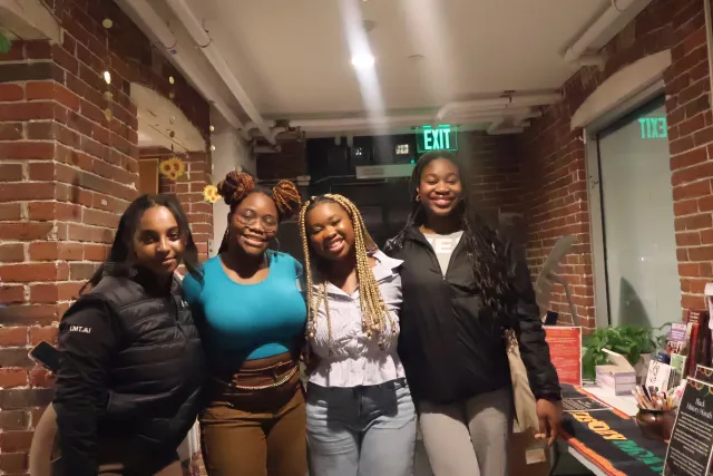 A picture of four black girls smiling and posing for a picture 