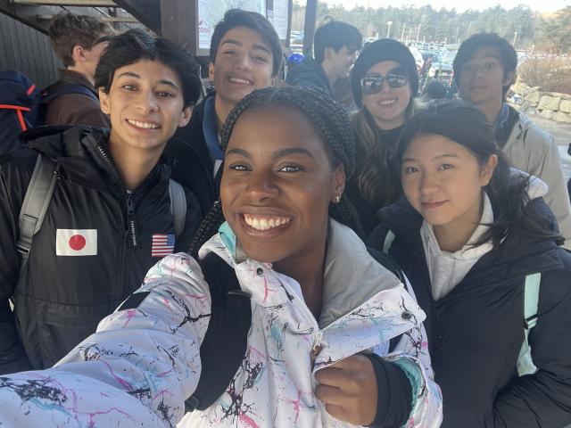 Group of students take a selfie in ski gear.