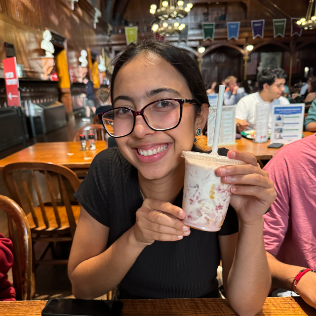 Meena holding up her created drink at Berg