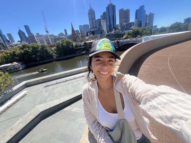 A smiling selfie on a sunny day with the Melbourne city skyline in the back