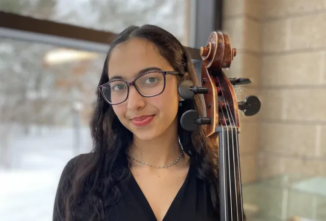 The author with her cello standing.