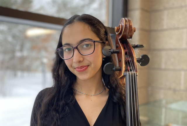 The author with her cello standing.