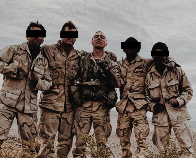 A group of soldiers pose for a picture during a training exercise
