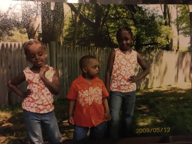 My siblings and I in matching Hawaiian Print outfits