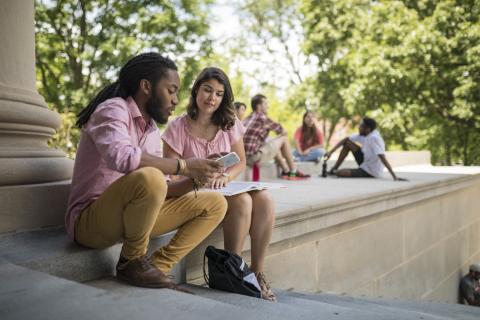 Two students looking at a cell phone