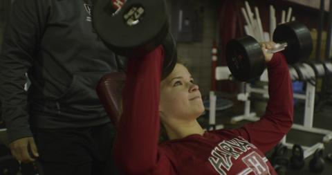 Student lifting weights