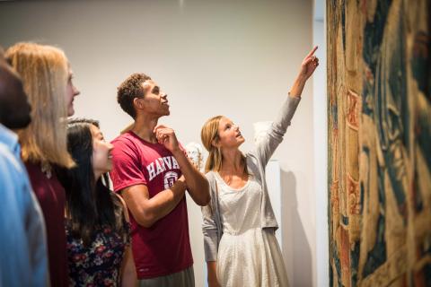 Students examining a piece in the art museums