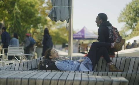 2 students talking in the science center plaza outsude