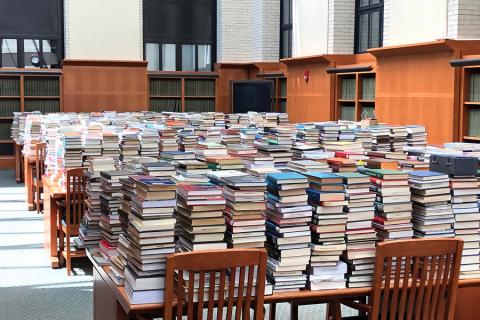 Returns were temporarily stored in the West Stacks Reading Room in Widener Library as they awaited processing by library staff.