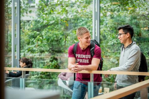 Two students speaking to one another