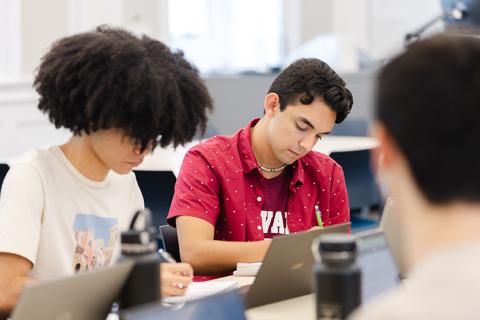 2 students in a classroom at a computer