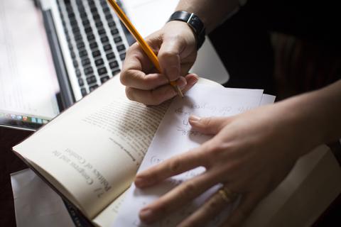 up close of person writing in a book