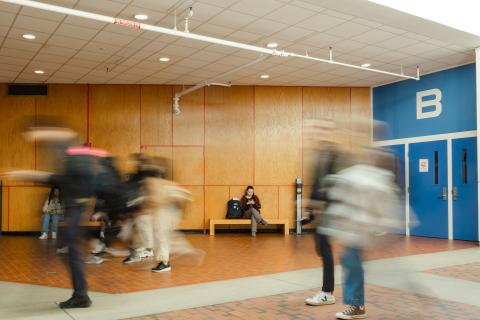 Students zipping by in the Science Center first floor lobby on campus.