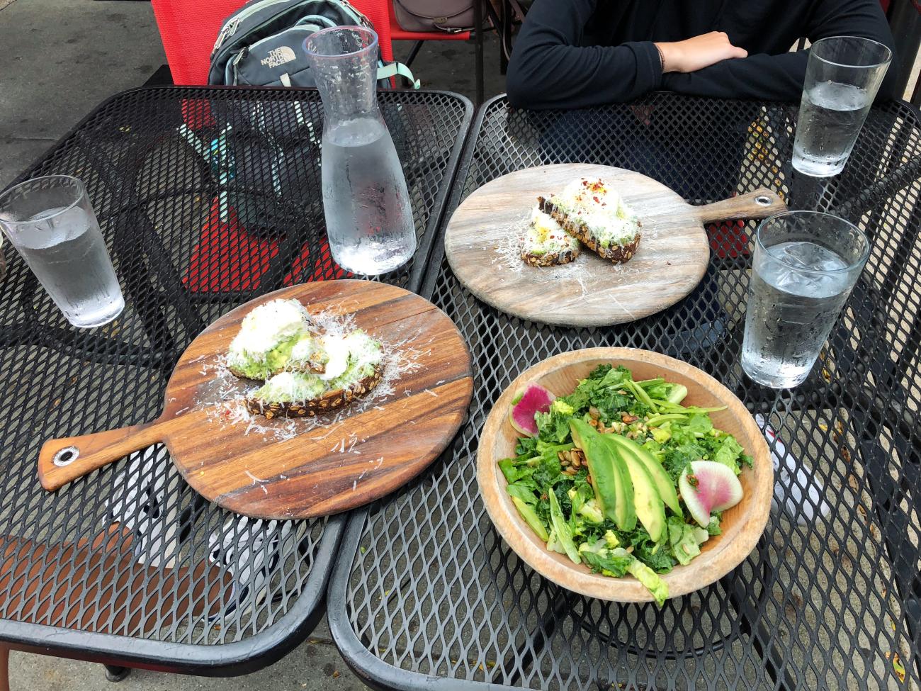 Salad and avocado toast on a table