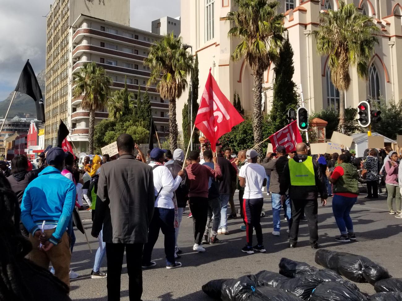 A coalition of activists protest in front of the parliament building in Cape Town, South Africa