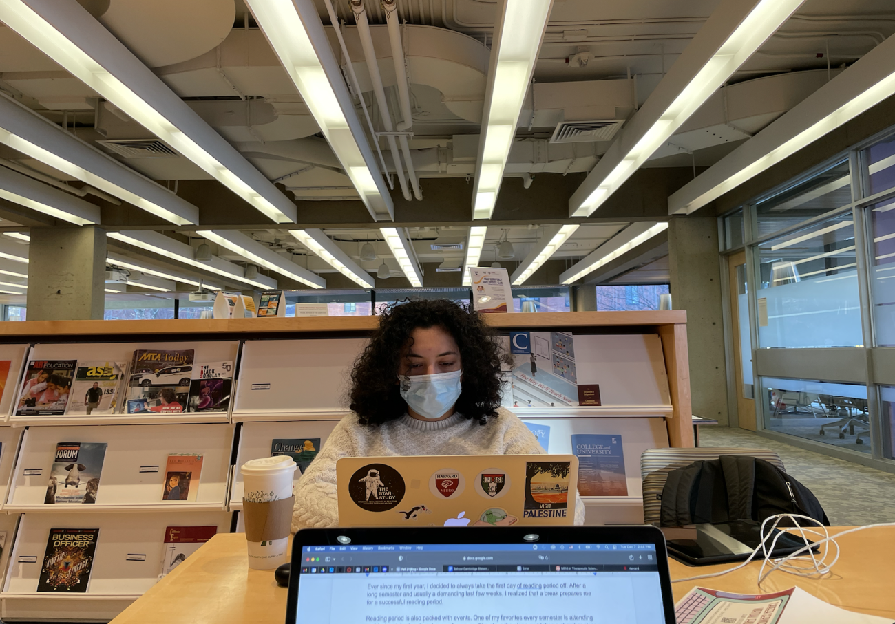 student typing on laptop in a common study area