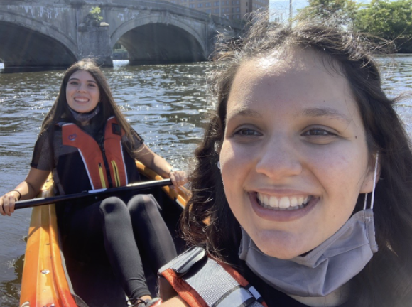 Me an my roommate in a kayak smiling for a picture while on the Charles River 