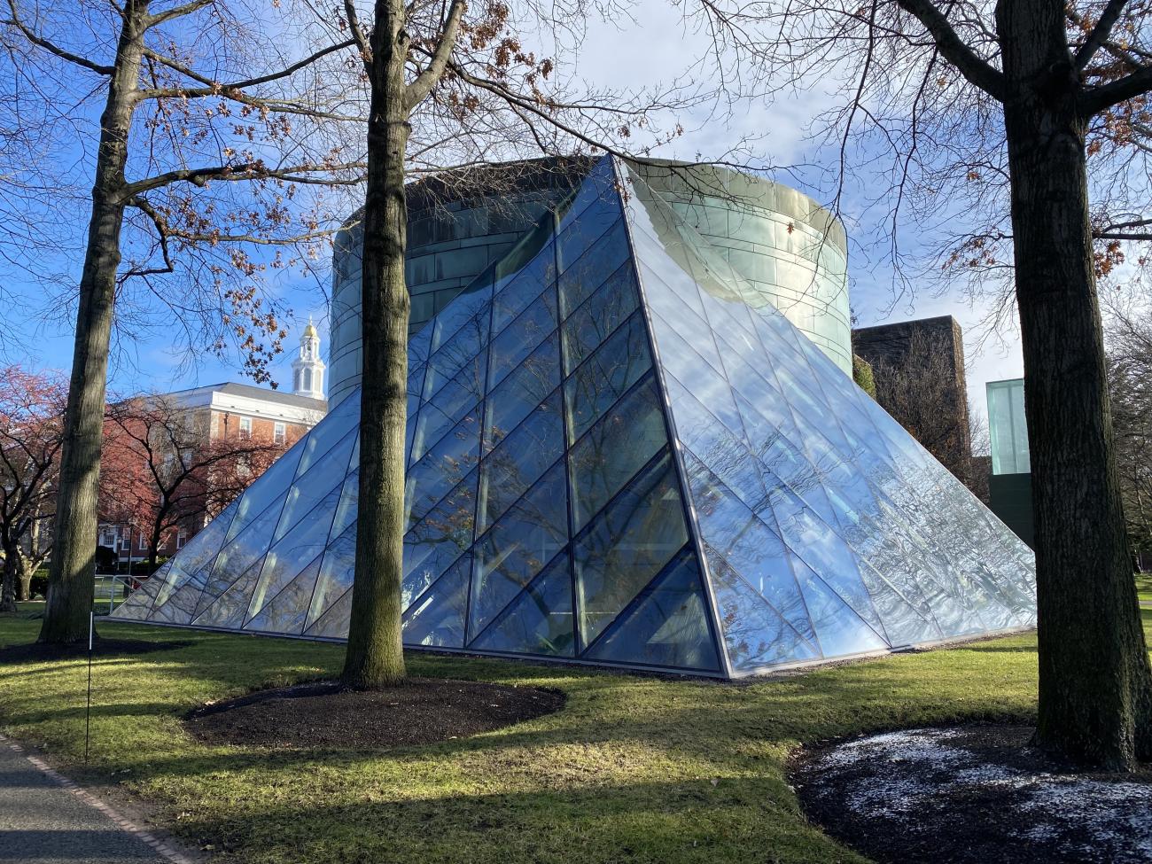 An outdoor view of the large, triangle Class of 1959 Chapel made with glass paneling.