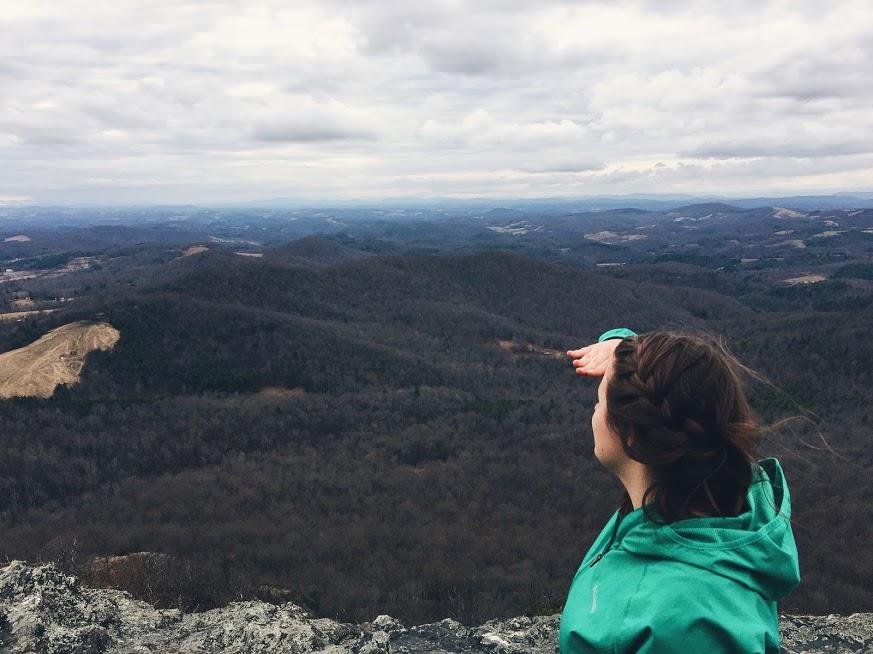 a student looking into distnace over mountains