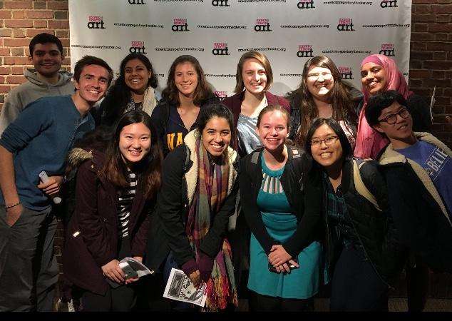 students posing together outside a play