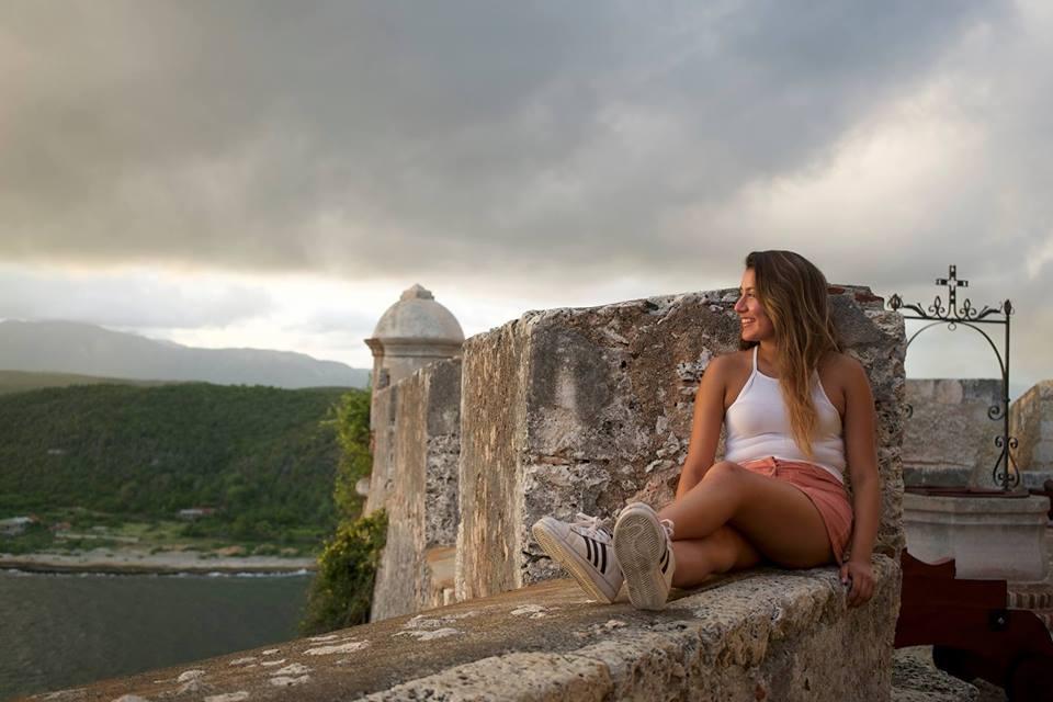 Student sitting on a ledge of a fortress in eastern Cuba