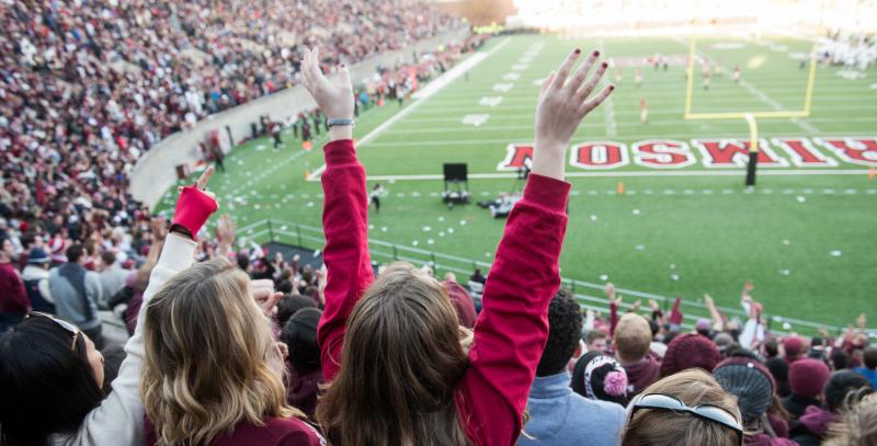 Students cheering at a Harvard football game