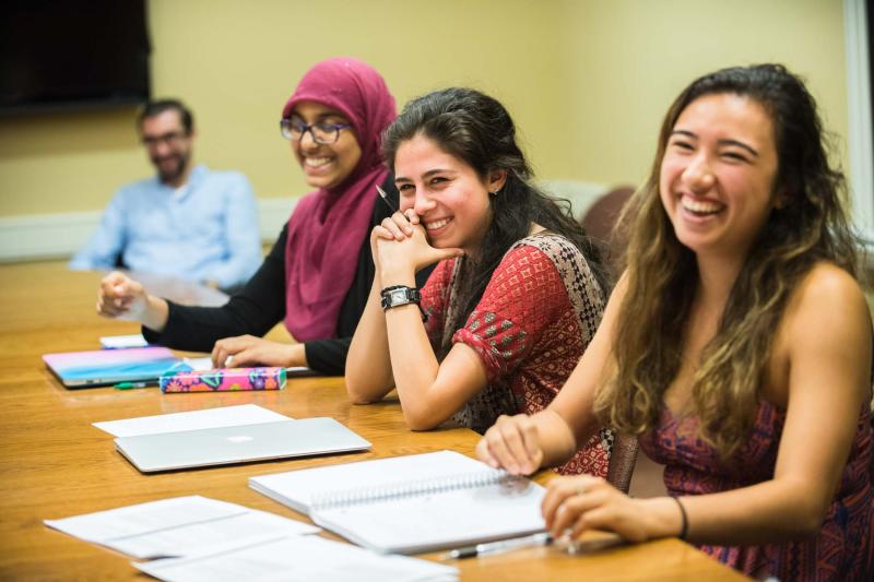 Three female students participating in a small class