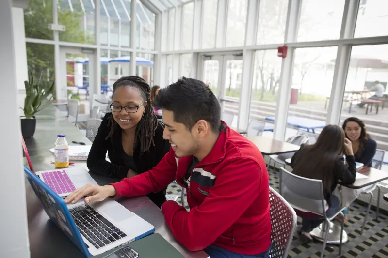 Two students looking at a computer screen