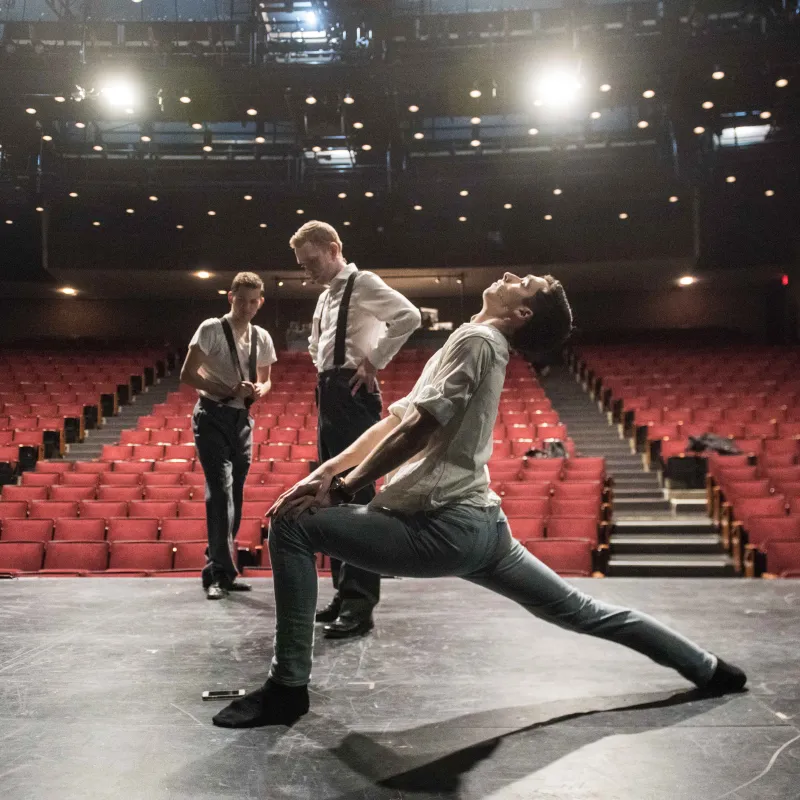 Three students warming up on stage