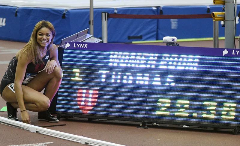 track student next to sign with her race time