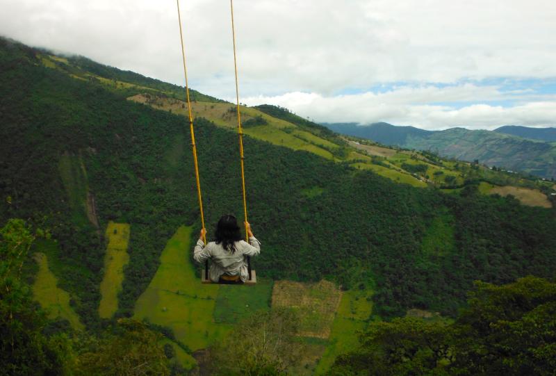 A girl sits on a swing in Ecuador