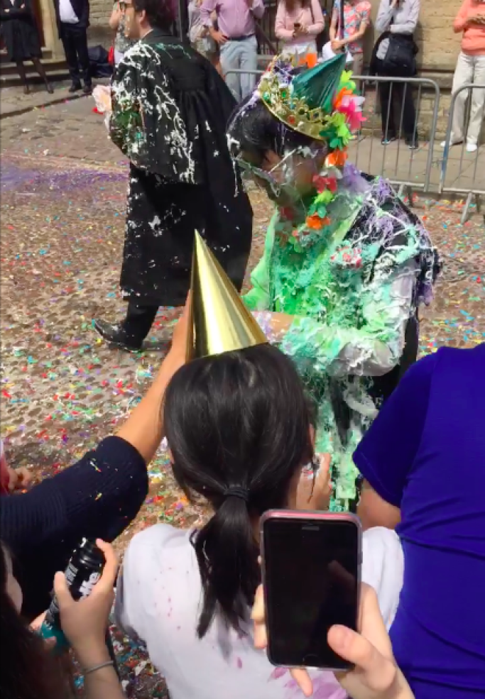 Student covered in whipped cream and powder paint