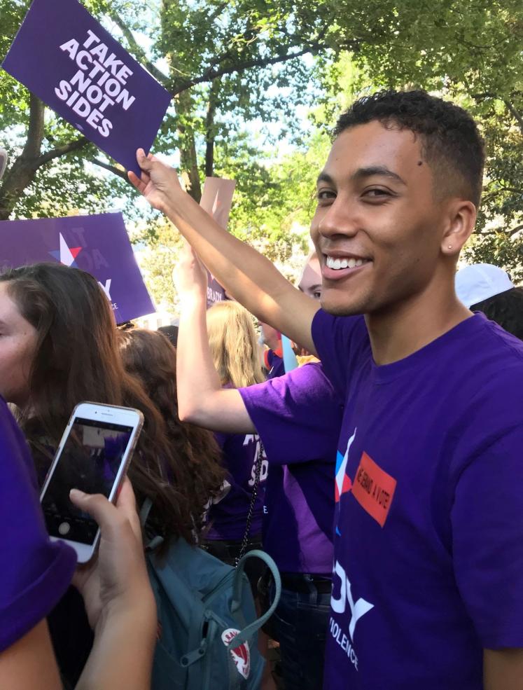 Gabriel holding a sign.