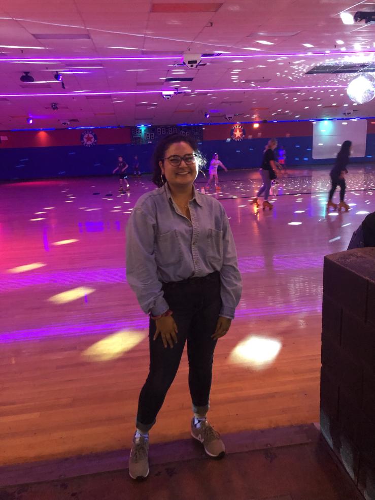 Maria posing in a skating rink. 