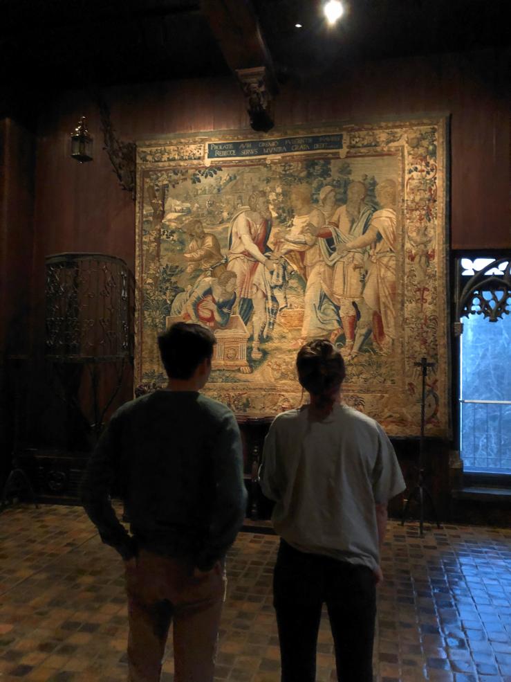 Friends looking at a tapestry in the Isabella Stewart Gardner Museum