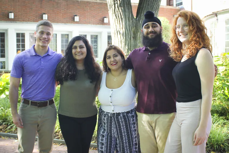 Ally, Harpreet, Braeden, Laura, and Maria standing together smiling