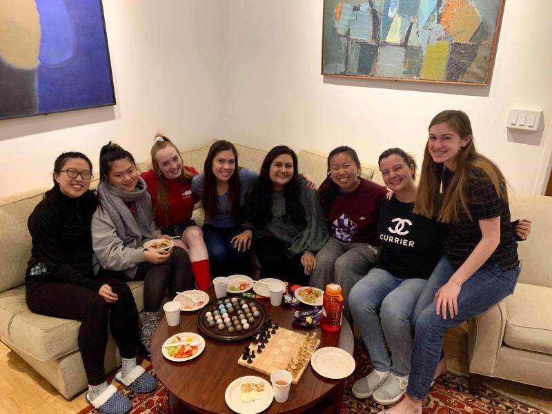 Maria posing with seven of her friends in Currier House, one of the upperclassmen dorms.