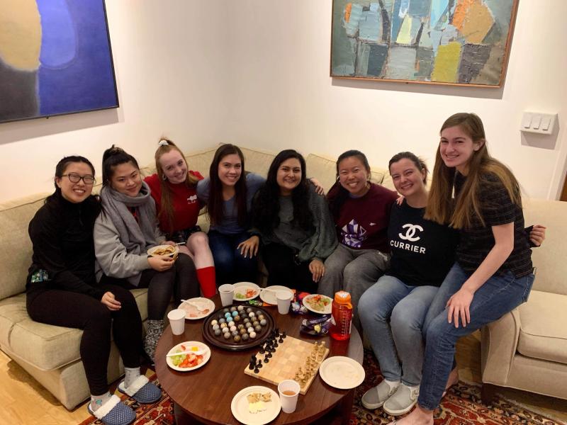 Maria posing with seven of her friends in Currier House, one of the upperclassmen dorms. 