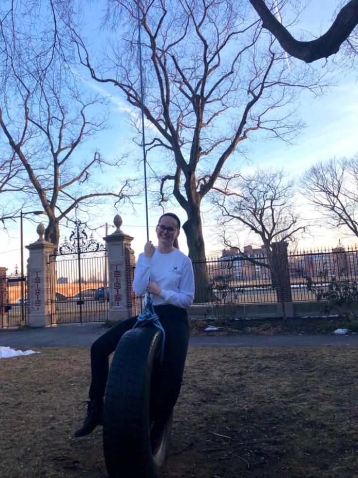 A photo of me on the tire swing in Winthrop Courtyard