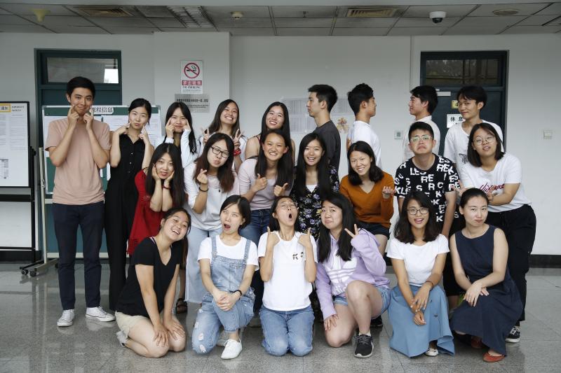 Group of students and teachers posing for a photo indoors