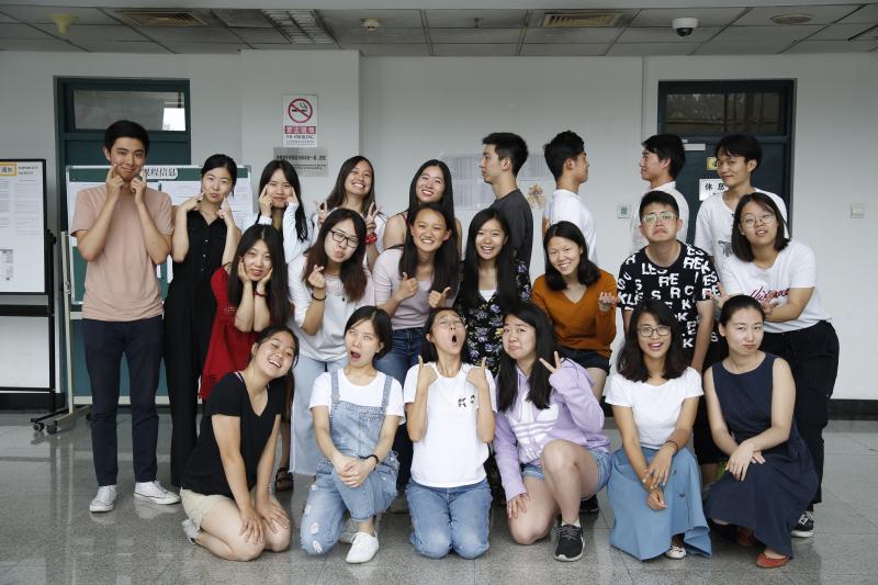 Group of students and teachers posing for a photo indoors