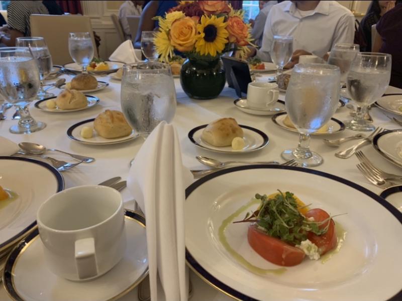 a table with plates of food and teacups