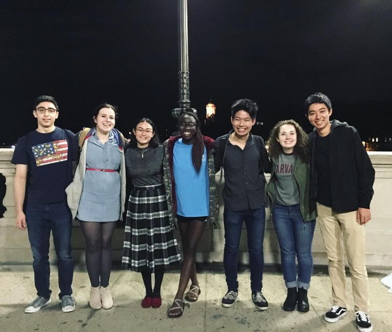 Group of seven people standing next to each otehr