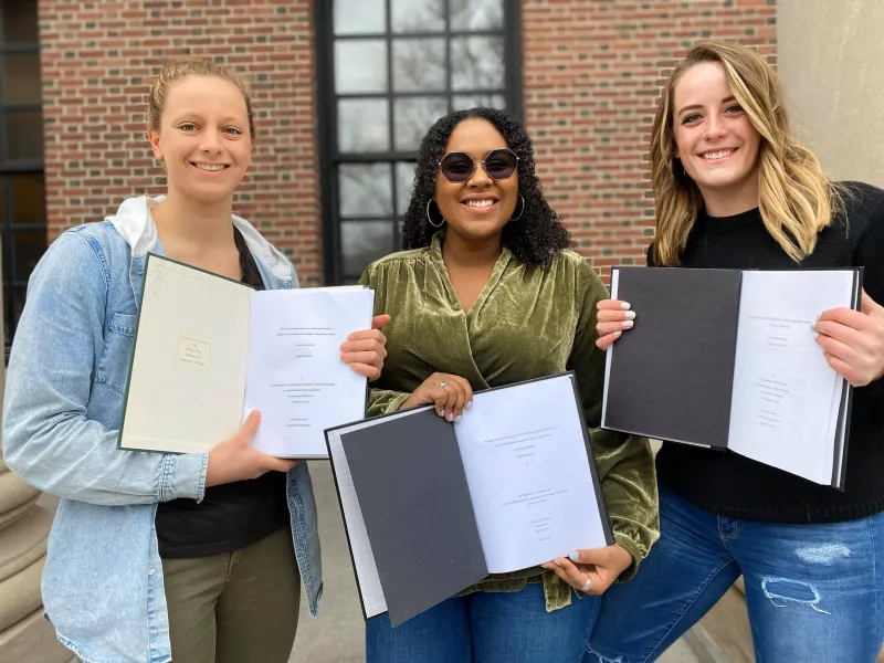 Me and my friends proudly displaying our finished Senior Honors Thesis papers just days before being sent home - March 2020