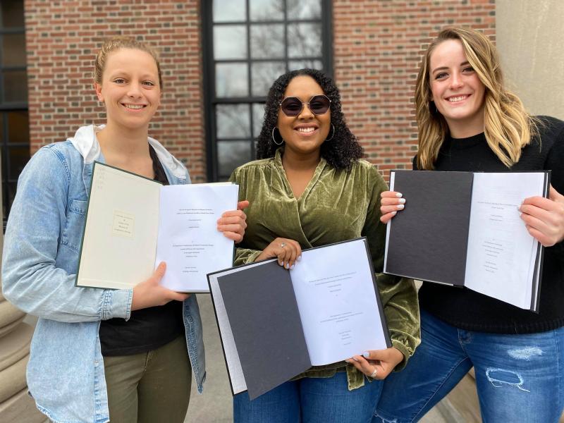 Me and my friends proudly displaying our finished Senior Honors Thesis papers just days before being sent home - March 2020